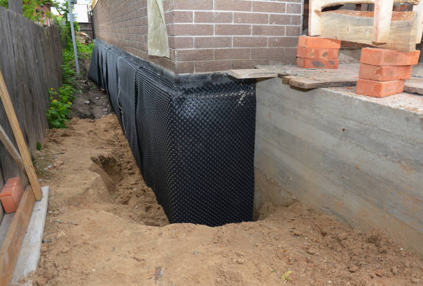 Happy homeowners after waterproofing job in Holley